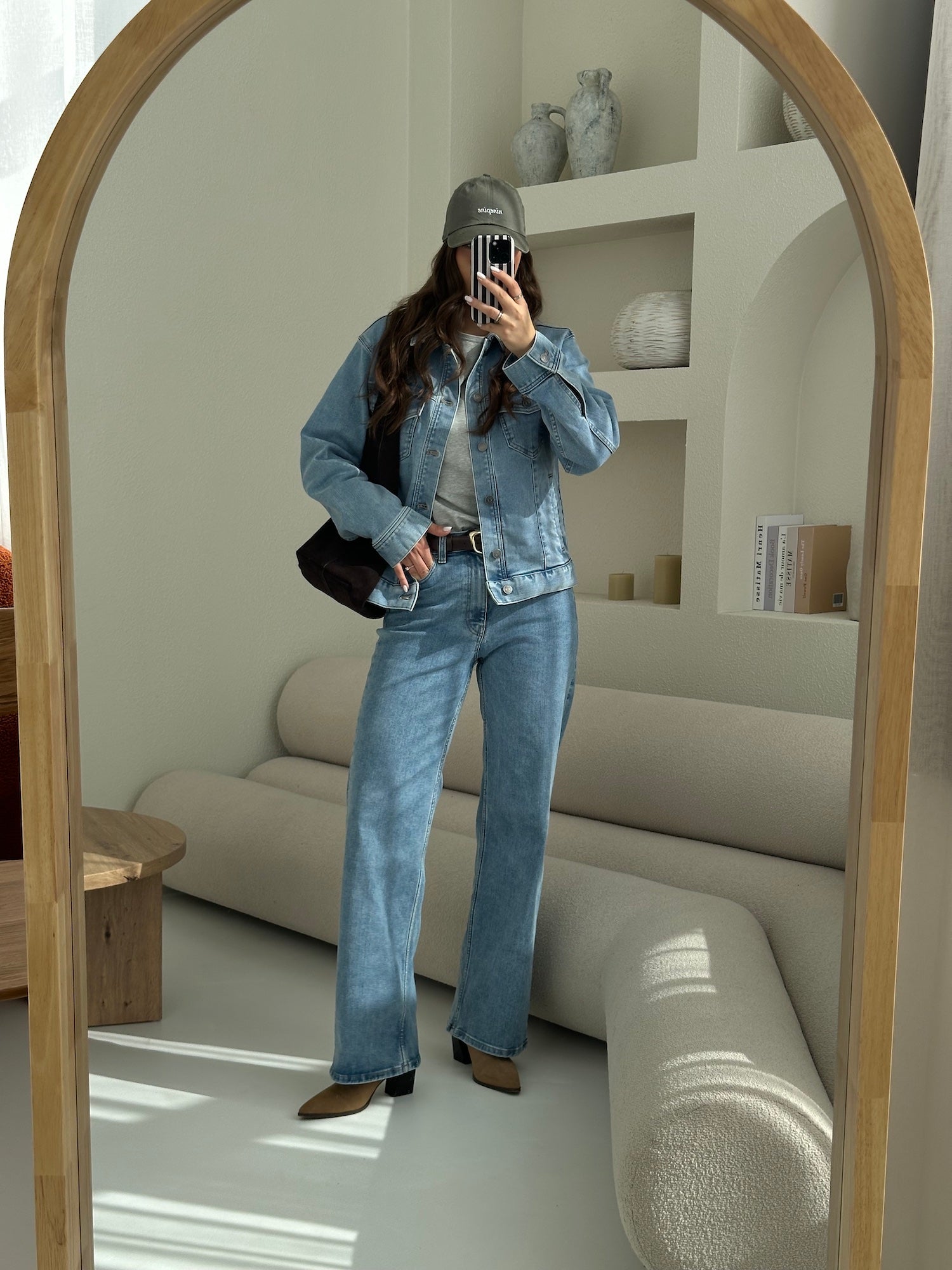 Woman wearing a light blue Stretchy ComfortDenim jacket, light blue Relaxed ComfortDenim jeans, and a heather grey Pima long-sleeve T-shirt styled with neutral accessories.