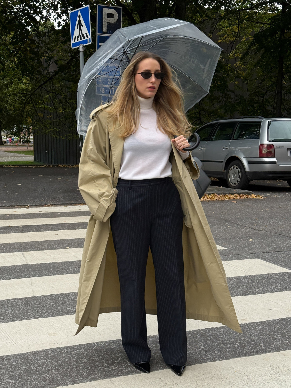 Woman wearing the Ninepine Flannel Daily Pant in navy pinstripe with a trench coat.